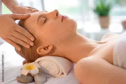 Young woman enjoying facial...