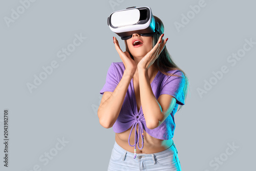 Surprised young woman using...