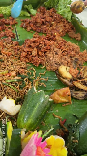 Traditional Asian Food Served on Banana Leaf with Cucumber and Spices