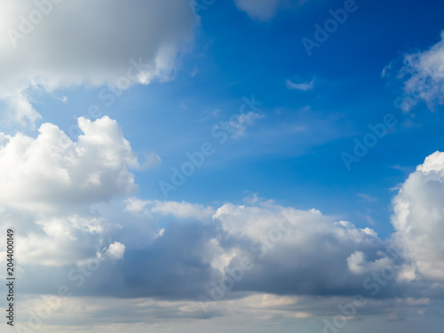 Blue sky with fluffy white clouds on a beautiful sunny day