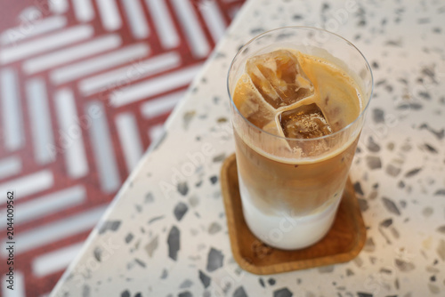 Cold coffee drink sits on table with patterned surface