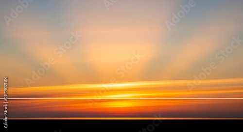 Stunning Sunset with Radiant Sunbeams Over Calm Horizon