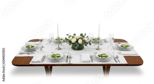A long, dark wood table set with white table runners, plates, utensils, glasses, and a floral centerpiece with white flowers and greenery