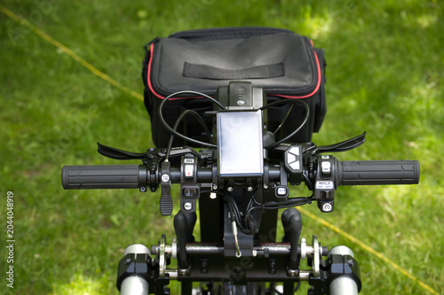Adaptive bicycle with hand controls and specialized braking system on grass