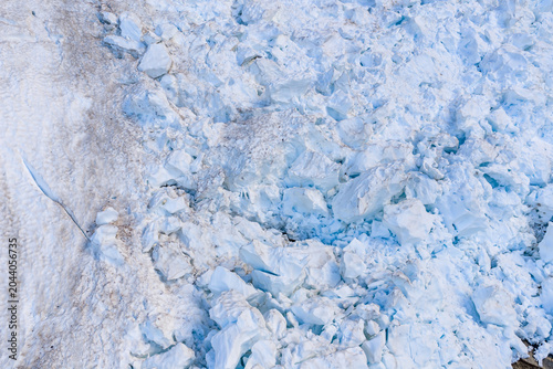 фотографія Aerial View Of Glacier Ice Crevasse And Broken Seracs On Rocky Glacier Edge In B