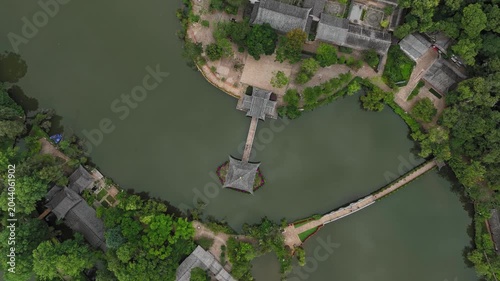 Aerial View of Traditional Chinese Pavilion and Bridge Over Calm Lake