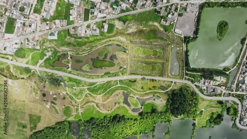 Aerial View of Urban Wetland Park with Ponds and Surrounding Buildings
