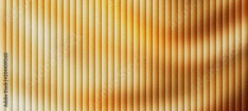 Quadro su tela Golden fluted wall panel texture, luxury vertical ribbed wood surface with warm lighting, elegant architectural interior design background, decorative linear wood slats for modern backdrop
