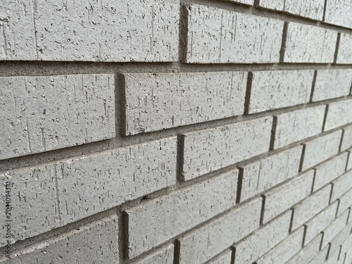 Perspective View of Yellowish Beige Brick Wall Texture Background. Side View of a brick wall. Yellowish brick wall with selective focus.
