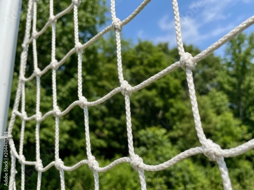 Close up of a white sports net against a blurred nature background