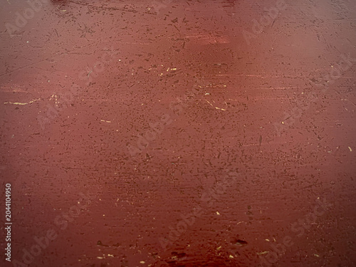 Red painted metal surface texture with scratches and worn details