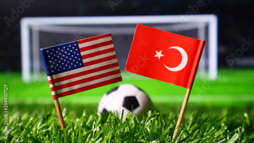 Tableau sur toile Small flags of the usa and turkey on a soccer field with a ball and goal in the