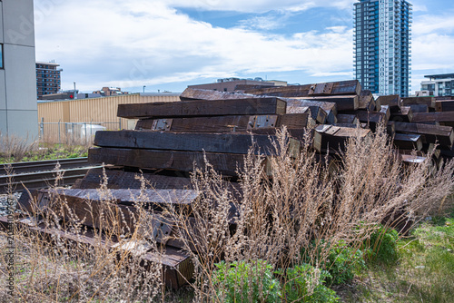 Used railway track ties sleepers beside a railway line