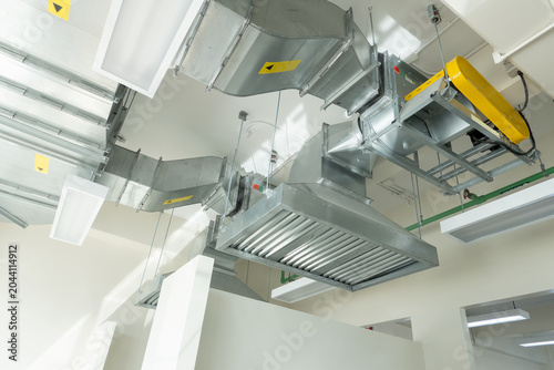 Cuadro en lienzo Industrial Ventilation System: A complex network of metal ducts and machinery forms an industrial ventilation system, showcasing a sophisticated mechanical installation within a building's ceiling
