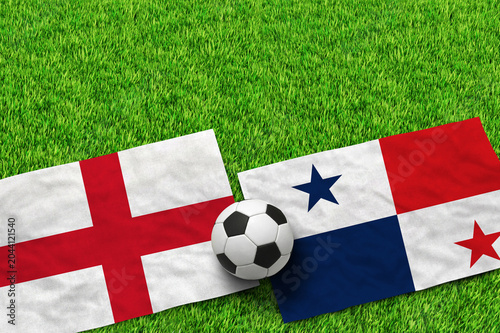 Foto England and Panama flags with soccer ball on green grass