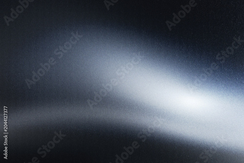 Minimalist dark charcoal metallic surface with subtle wave textures and soft silver center highlights