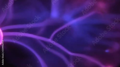 Electric plasma filaments dance and glow in vibrant blue and purple hues. This mesmerizing abstract light display creates a dynamic, energetic background.