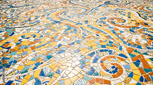 Vibrant ceramic mosaic floor with colorful spiral patterns and geometric tile fragments in blue, yellow, and orange, creating a decorative textured surface.