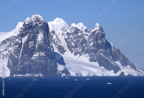 Bild auf Leinwand spectacularly steep Antarctica peaks and icebergs on a sunny summer day in the n