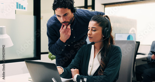 Business  people and laptop with headset at call centre for advice  helpdesk and inquiry for finance. Team  agent or helping with pc for customer service  assistance and guidance for financial refund