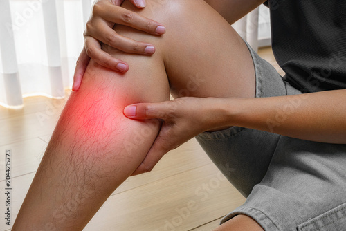 Cuadro en lienzo Person holding shin in pain indoors, healthcare image for medical treatment, therapy, recovery, and wellness advertising