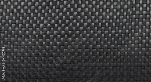 Carbon fiber tileable texture with dark grey and black woven pattern, ideal for modern abstract backgrounds, industrial design, and seamless fabric surface designs.