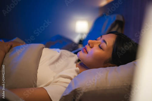 Bild auf Leinwand Beautiful asian woman lying in the bed at night