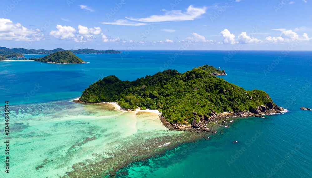 Fototapeta premium Aerial view of tropical island with turquoise waters and sandy beach.