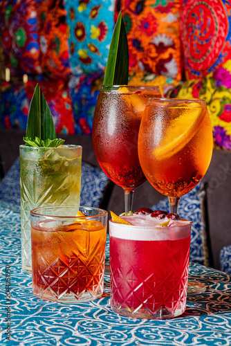 Colorful cocktails create a lively atmosphere in a vibrant bar setting with joyful decor