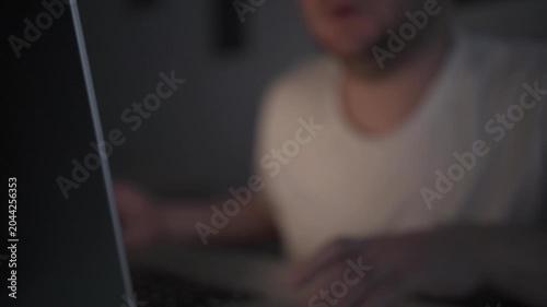 Businessman Checking Smartphone While Working on Laptop