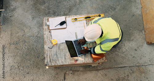 Konstfotografi Documents, laptop and above of man on construction site for planning, building permit and compliance
