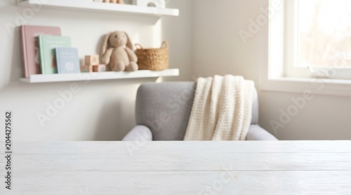 Empty white wooden tabletop foreground with high copy space, blurred baby room background with soft armchair, blanket, shelves, books, and cute knitted rabbit toy for children product display.
