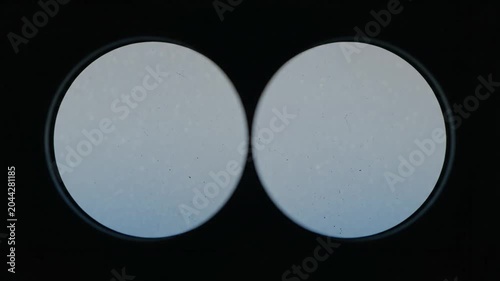Abstract view through binoculars on solid black background