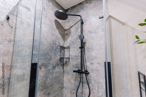 Konstfotografi Modern black shower fixture with overhead rain showerhead and glass enclosure in