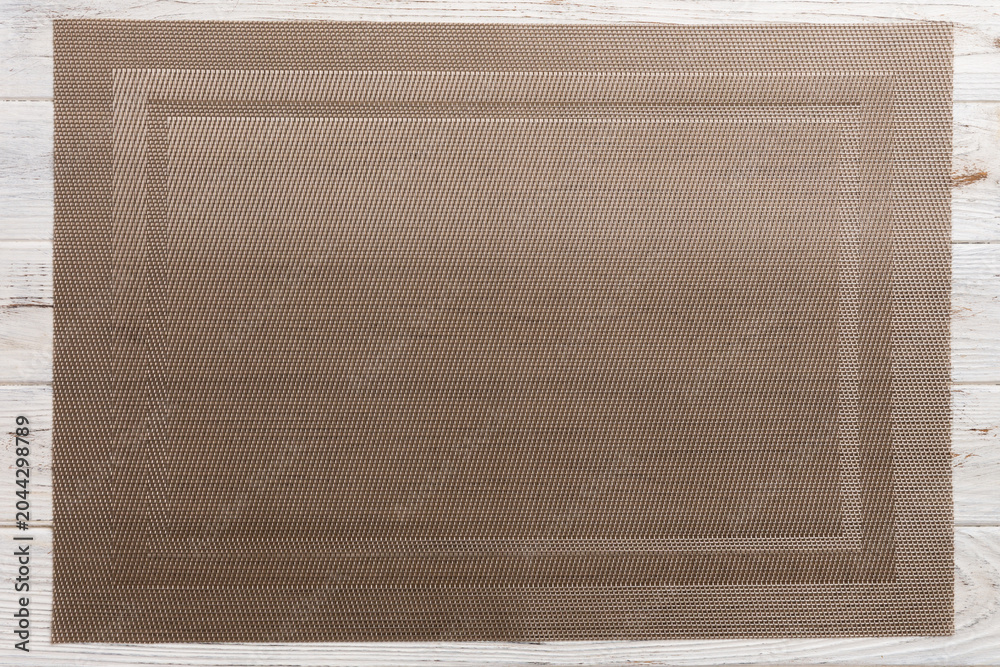 Obraz premium Top view of brown tablecloth for food on wooden background. Empty space for your design