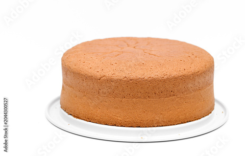 Fotografie Baked round sponge cake for a birthday cake