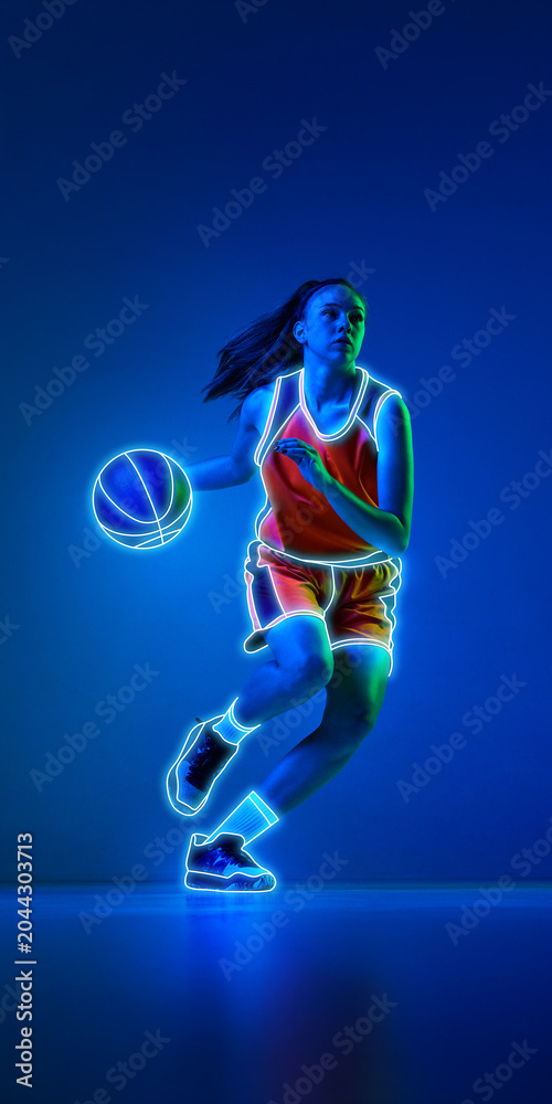 Naklejka premium Female basketball player dribbling with glowing neon lines on blue background. Concept of sportswear advertising, youth league promotion, basketball academy banners, and fitness campaigns.