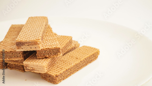 Sweet wafers filled with chocolate and vanilla cream isolated on a white background