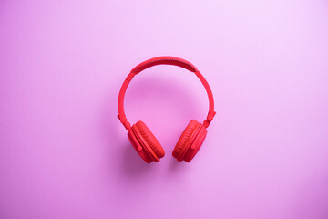 Wireless red headphones on pink background