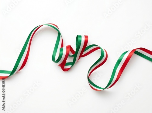 Curved satin ribbon in red green and white colors on plain white background