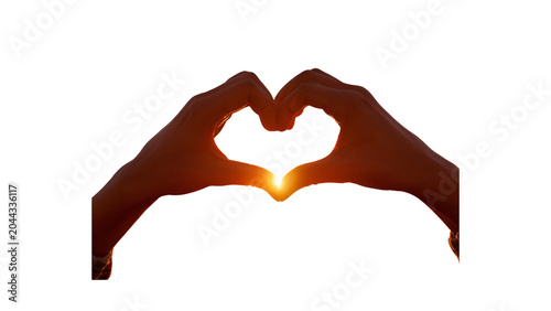 A dramatic close-up silhouette of hands creating a heart gesture, illuminated from behind by a warm