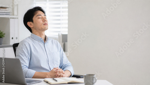 Relaxed man breathing calm at office
