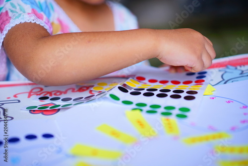 POV children's hand playing and learning about number with stick dot. Colorful paper shape. Educational logic toys for kids. Montessori method games for child development and logical education.