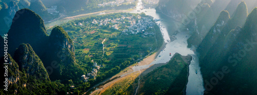 Obraz na płótnie Aerial high-angle shot of winding Li River passing through karst peaks and river