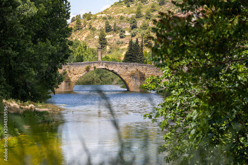 Old medieval stone bridge over a calm river in Valderrobres Spain