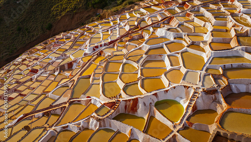 Bild auf Leinwand Aerial view of the maras salt mines in peru with thousands of ancient terraced p
