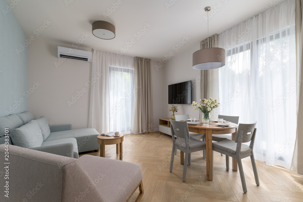 Fototapeta premium Modern bright living room with dining area and air conditioning