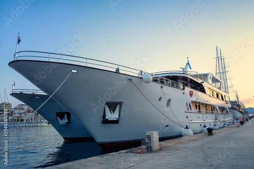 Beautiful view with a large tourist ship docked at the harbor of the old town of Trogir, Croatia