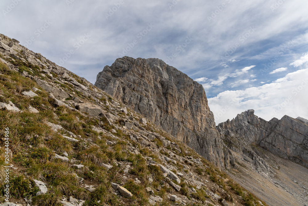 Fototapeta premium Scenic alpine mountains near the Col de la Colombière in the Bornes-Aravis massif with green meadows and rugged peaks, Haute-Savoie, French Alps