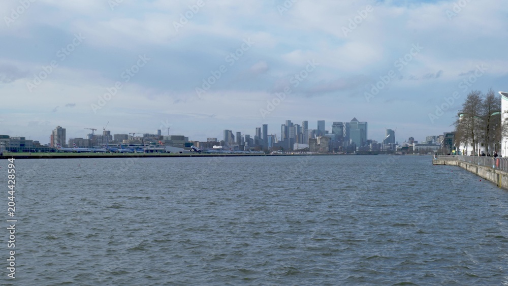 Obraz premium Canary Wharf Skyline Across River With London Waterfront and Modern Office Skyscrapers
